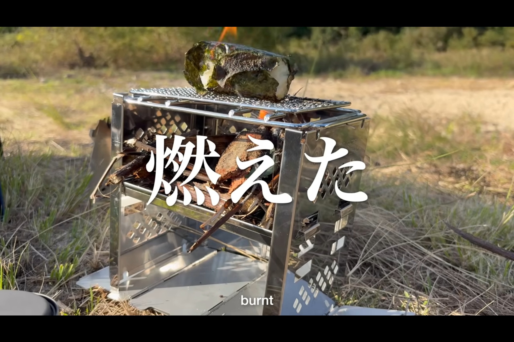 焚火台の網の上でスーパーのおにぎりを焼きおにぎりにしようとしたら海苔に火が付いた